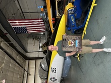 Airman poses in front of jet.