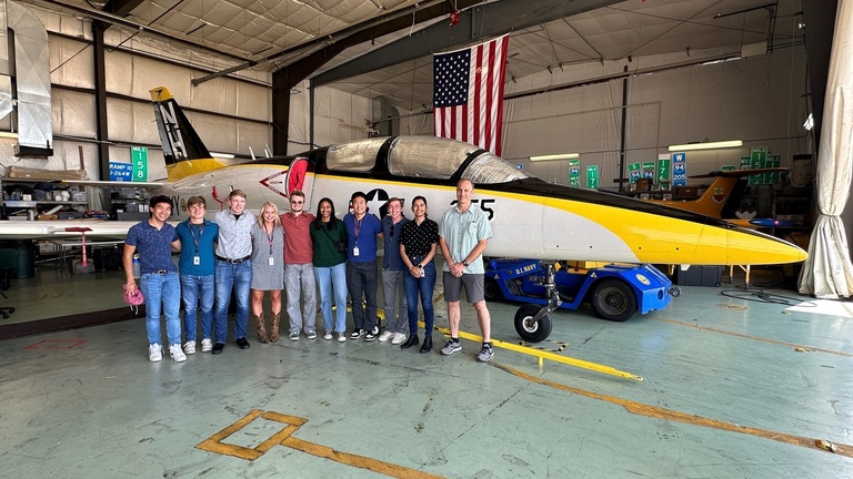 Tour group in front of an OPL jet