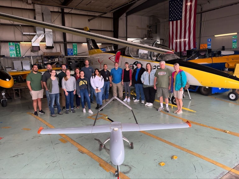 A group of people in the OPL hangar