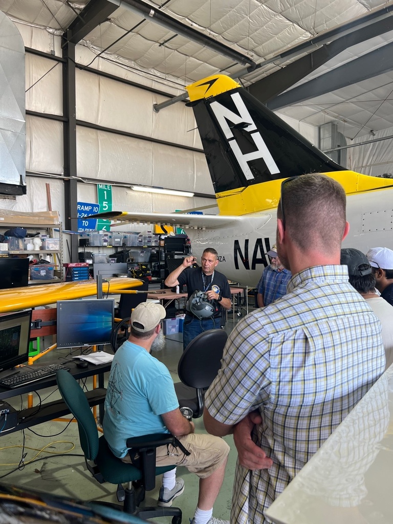 Tom Schnell talks to a tour group in the OPL hangar