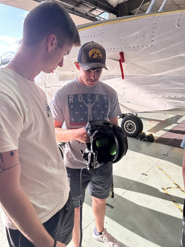 Two students examine flight equipment