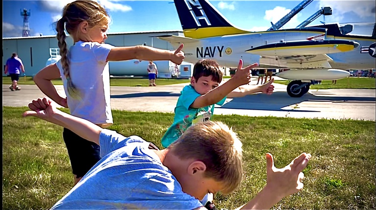 Children play near a parked jet