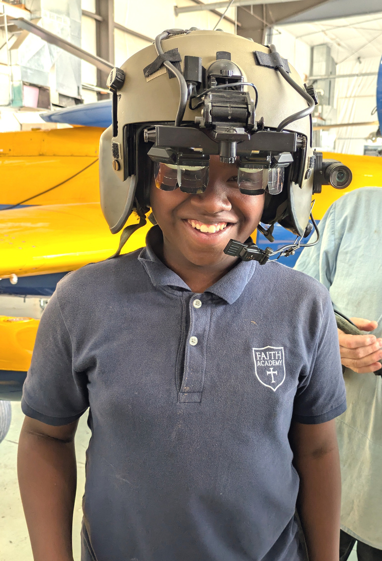 Student tries on pilot helmet