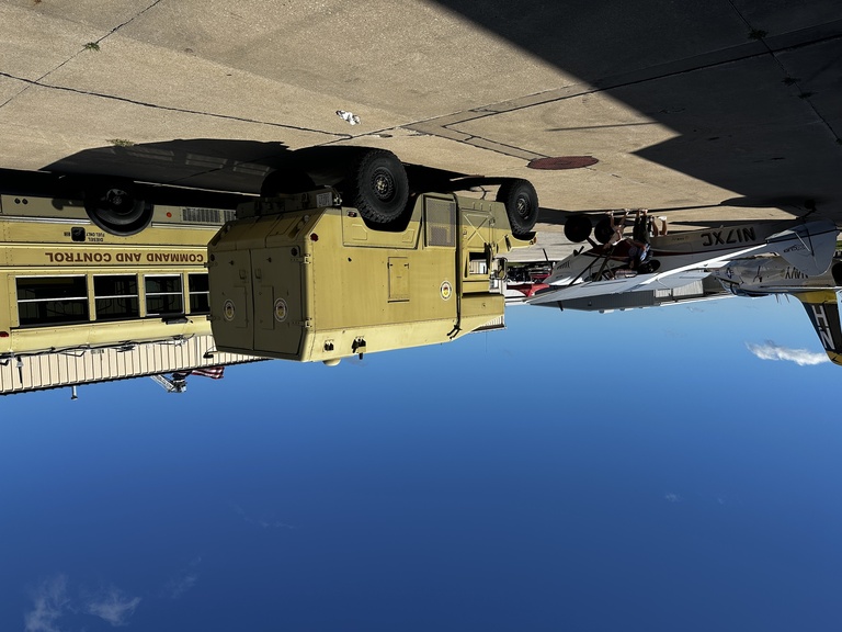 OPL humvees are parked outside OPL hangar