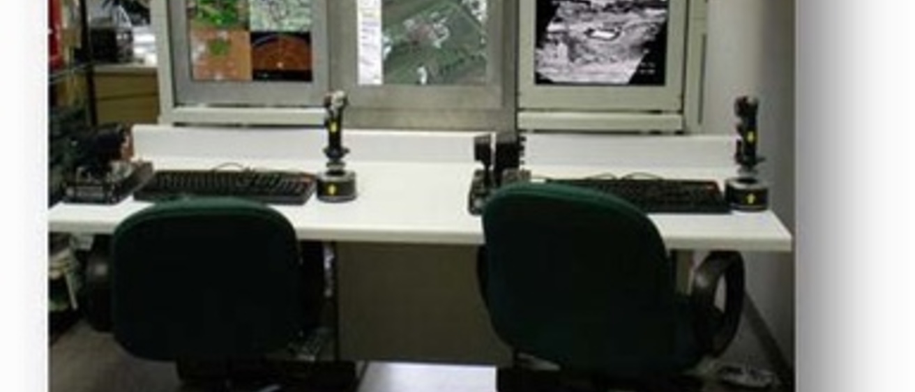 A workstation for two people in front of six monitors