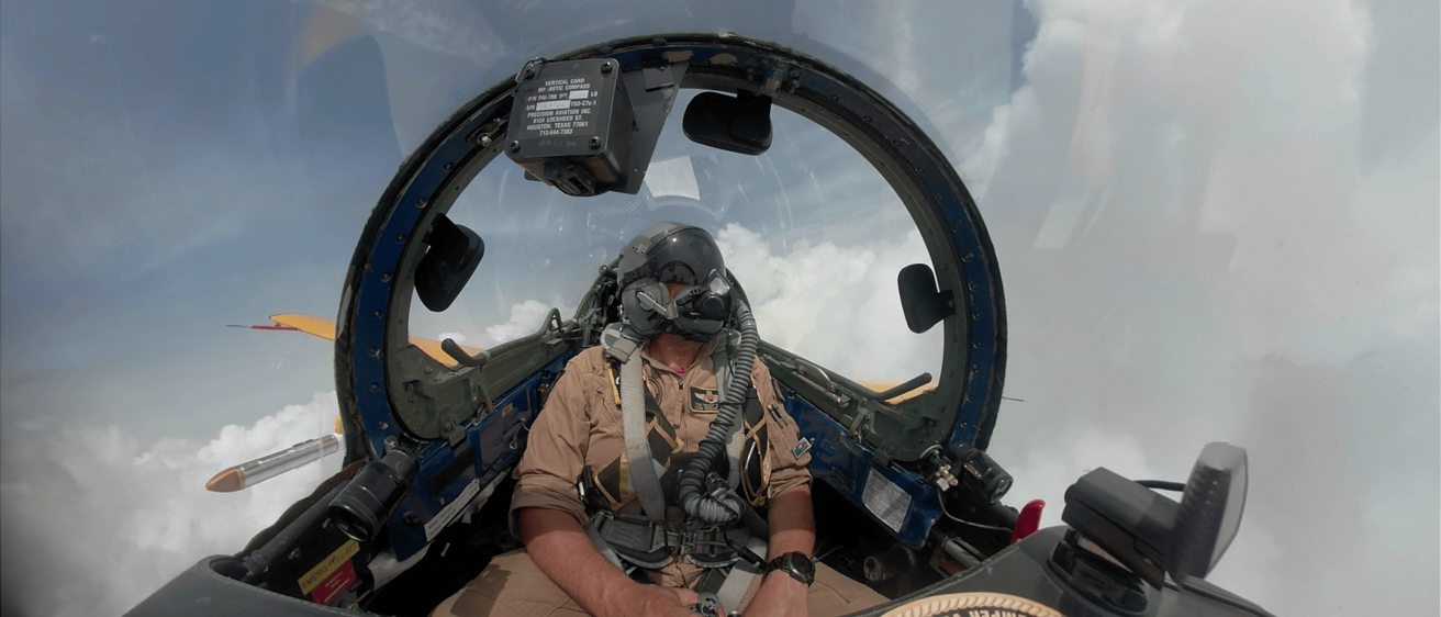 Photo of a pilot in the cockpit while in the air