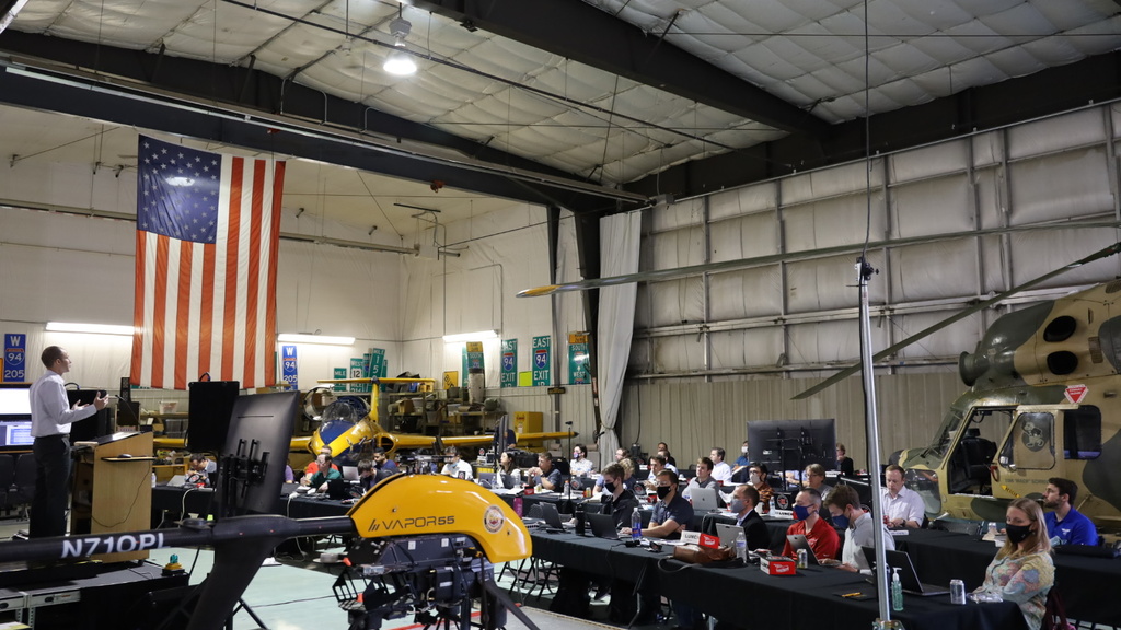 People listening to a presentation in the OPL hangar