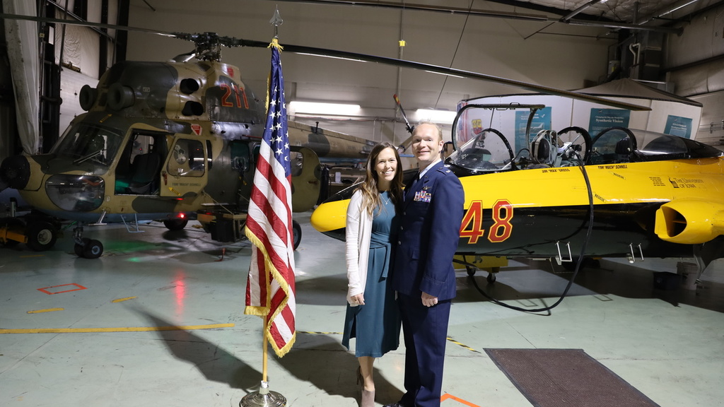 Patrick Highland and his wife pose for a photo in the OPL hangar