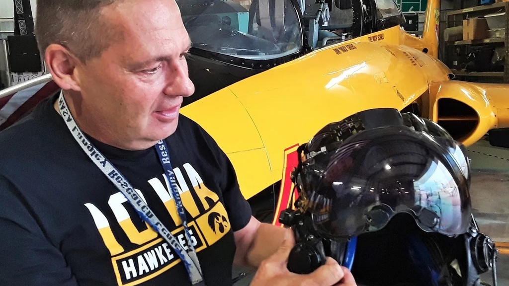 Tom Schnell holds a helmet in the OPL hangar