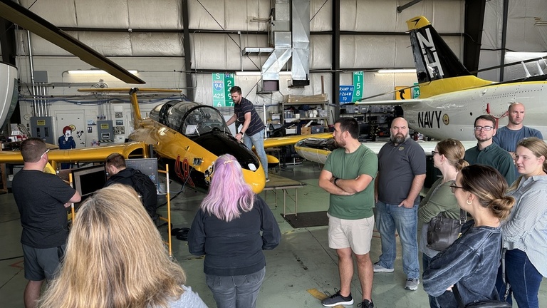 A group of people in the OPL hangar