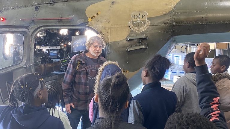 A tour group inside the OPL hangar